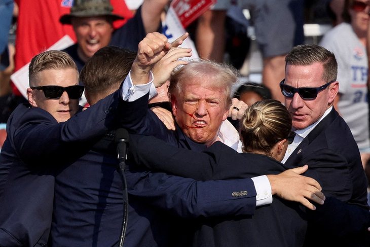 trump-bi-ban-reuters-173253044383631232620 Bức ảnh ông Trump giơ nắm đấm cùng quốc kỳ đi vào lịch sử nước Mỹ - Ảnh 1.